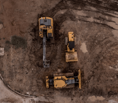 aerial-photo-of-excavator-road-roller-and-bulldozer-1579356